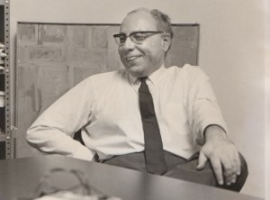 Image of EJ relaxing in a chair during an interview.